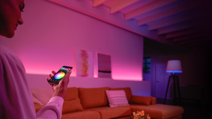 Donna che controlla le luci colorate nel soggiorno