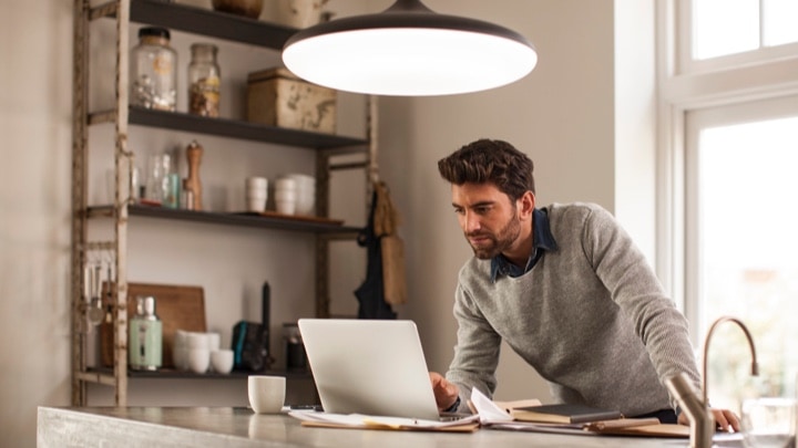 un uomo che lavora sotto un apparecchio per illuminazione connesso